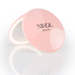 The Nikol Beauty 10x Magnification Mirror is a round, pink compact with the brand name on the lid, partially open to display its precise mirror, shown against a white background—perfect for detailed makeup touch-ups.
