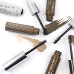 Open tubes of high-pigment Brow Mascara in brown and taupe from Nikol Beauty with applicator brushes on a white background, showcasing defined eyebrow shades and sleek packaging.