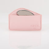 A pink leather pouch embossed with Nikol Beauty holds the Gua Sha Stainless Steel tool, partially visible inside and ideal for lymphatic drainage, set against a white background.