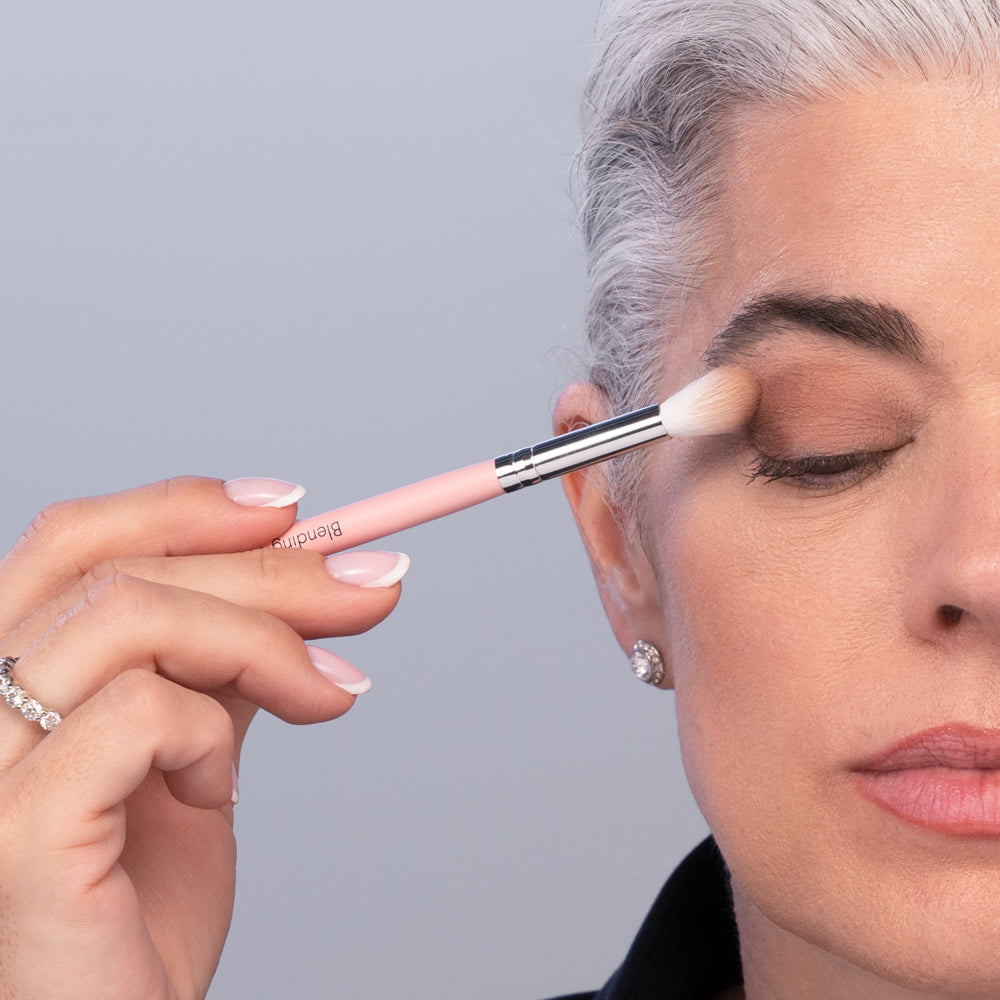 Nikol sweeping the soft Blending brush across her eyelid