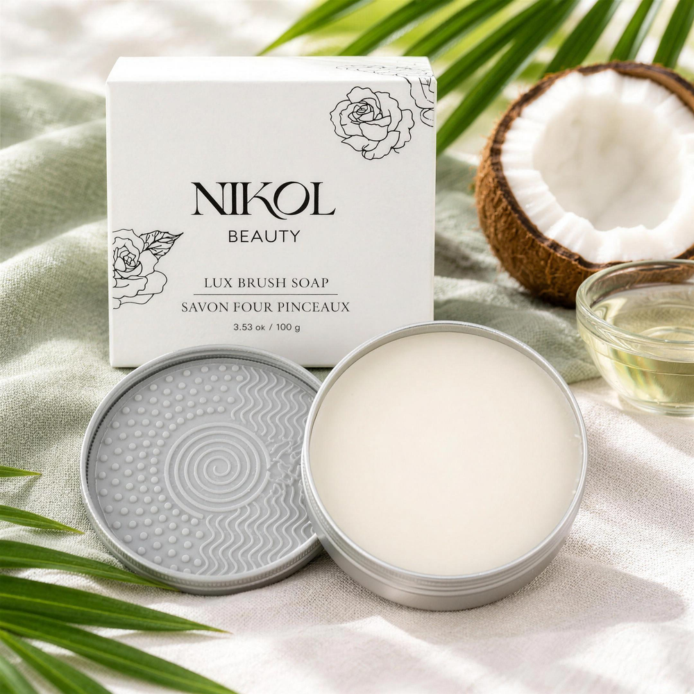The open Lux Brush Soap tin and scrubber lid with its box, a fresh coconut, palm leaves and coconut oil