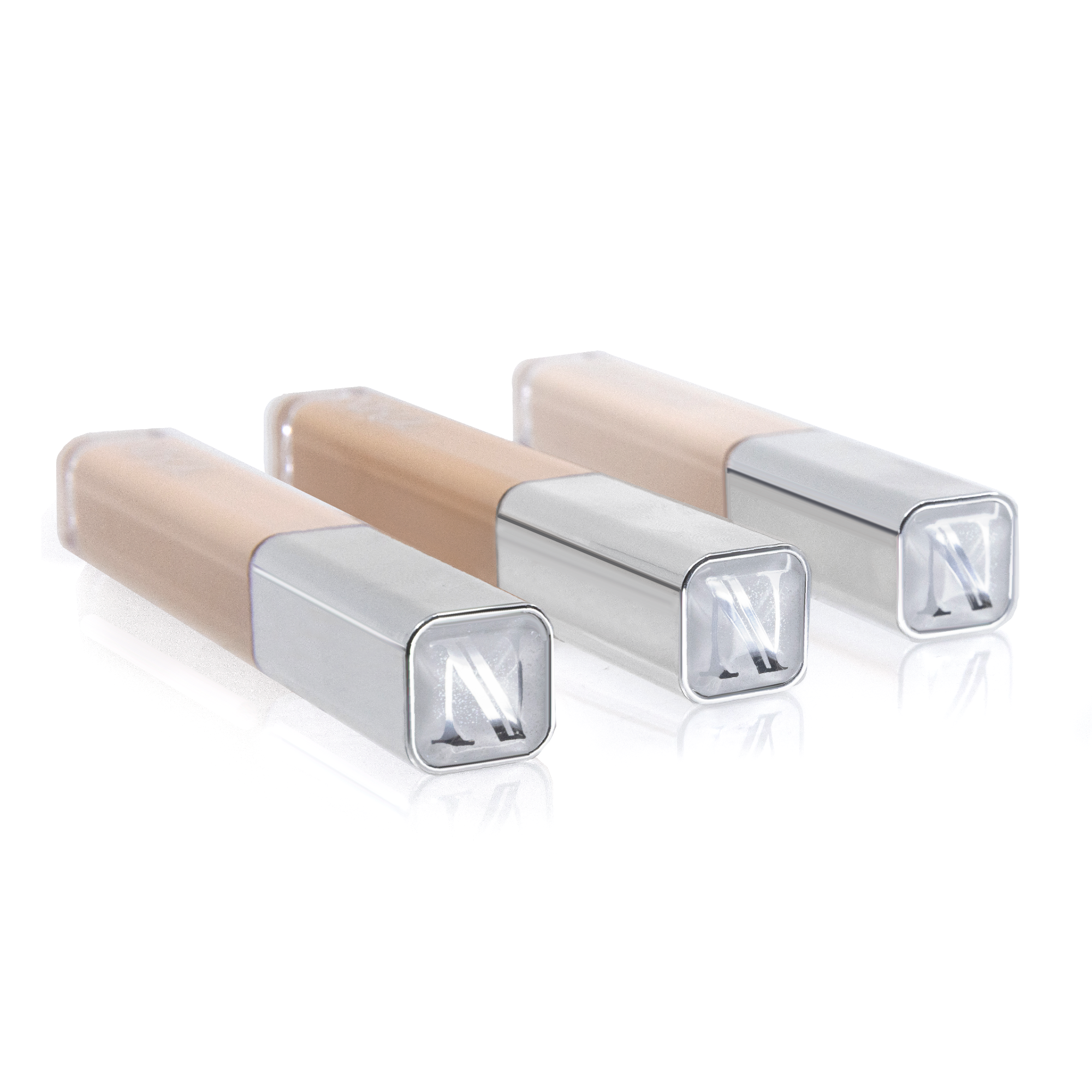 Three Creamy Concealer tubes with silver N caps lying side by side, showing the creamy shades through the clear bodies