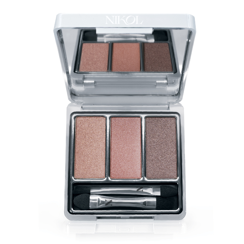 The Naughty Nancy 3-Well Eyeshadow Palette by Nikol Beauty features shimmery, long-wearing peach, pink, and bronze shades plus a dual-ended applicator in a silver compact labeled “NIKOL.”.